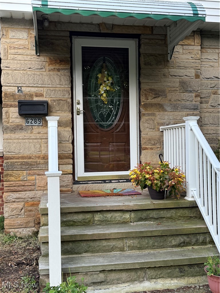 6289 Manchester Road Parma, OH 44129 - Photo 7 of 46 View of exterior entry with stone siding and a porch