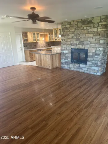 a kitchen with stainless steel appliances wooden floor and a sink