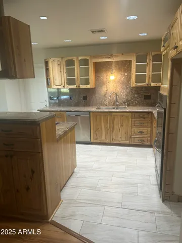 a kitchen with stainless steel appliances granite countertop a sink and cabinets