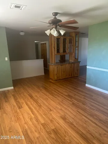 a view of a room with wooden floor