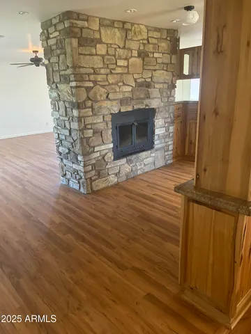 a room with a wooden floor and a fireplace