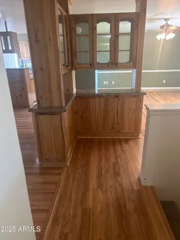 a view of a door and wooden floor in a room
