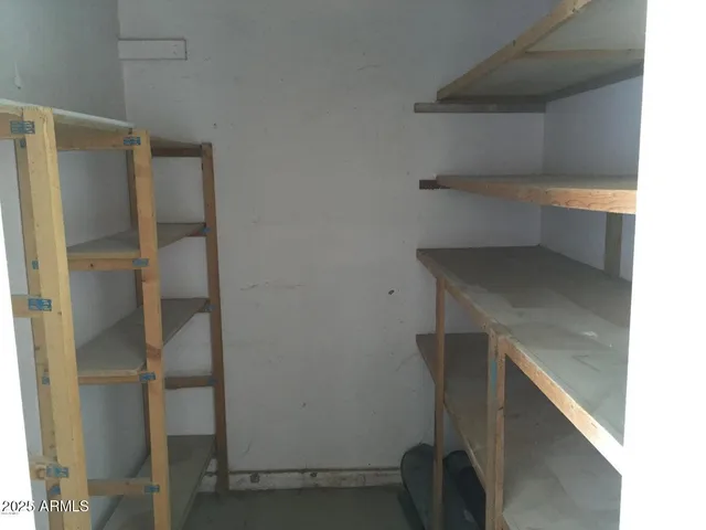 a view of storage and utility room with washer and dryer