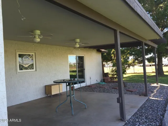a backyard of a house with table and chairs