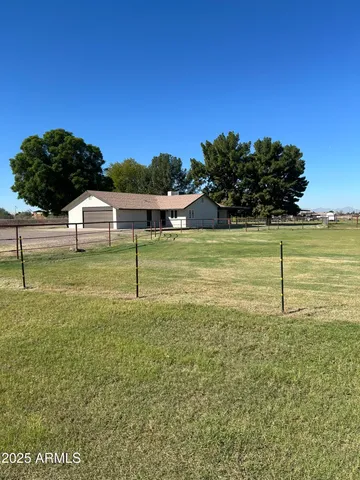 a white house with a yard