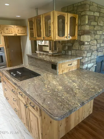a kitchen with sink stove and cabinets