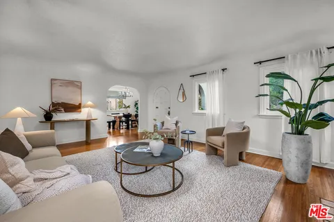 a living room with furniture potted plant and a couch