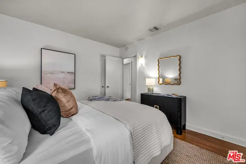 a bedroom with a bed and a lamp