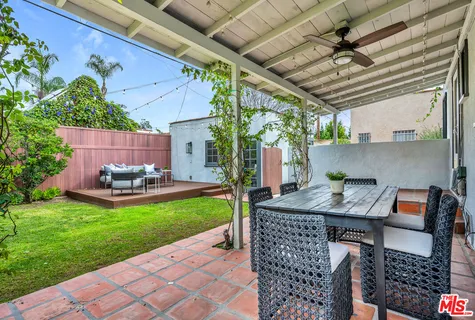 a view of a backyard with furniture and garden
