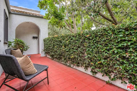 a view of entryway with flower garden and stairs
