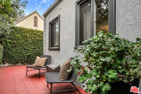 a backyard of a house with outdoor seating