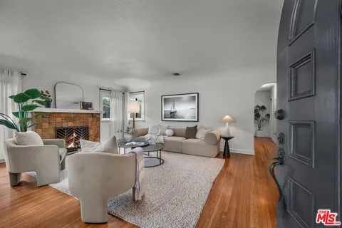 a living room with furniture a fireplace and a table
