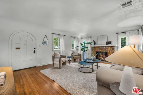 a living room with furniture a fireplace and a table