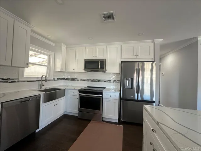 a kitchen with a sink stove and refrigerator