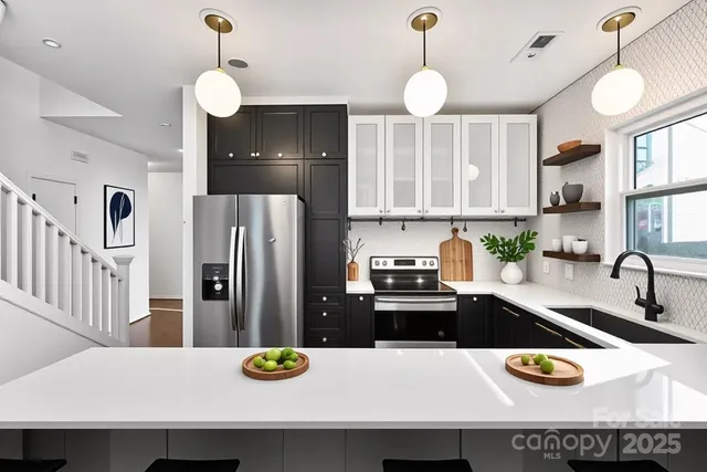 a kitchen with a refrigerator a sink and a stove