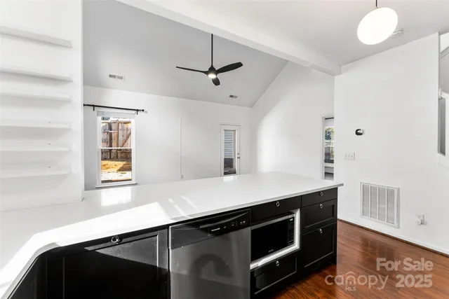 a kitchen with stainless steel appliances a sink and a stove