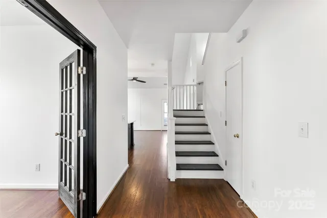 a view of a hallway with wooden floor and entryway