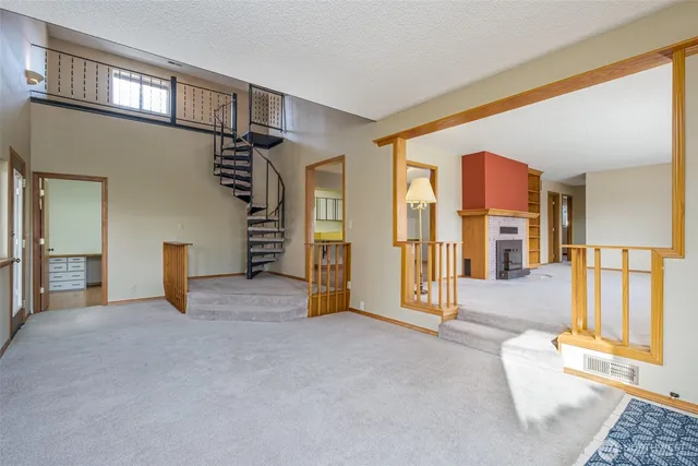 wooden floor in an empty room with a fireplace