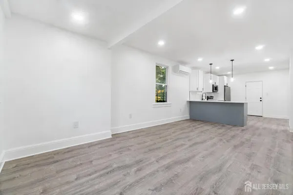 a view of a kitchen with a sink and a refrigerator