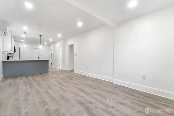 a kitchen with stainless steel appliances a sink a stove a refrigerator cabinets and a window