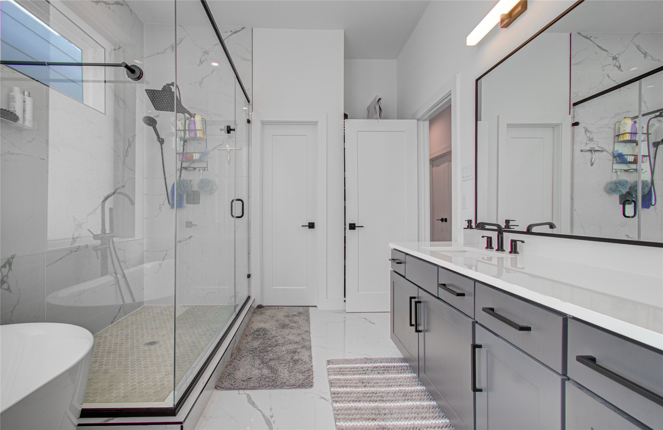 3032 Lamar Street Houston, TX 77003 - Photo 33 of 37 a spacious bathroom with a shower sink and mirror