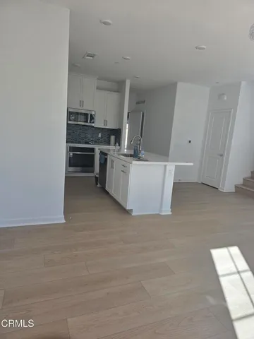 a view of kitchen with cabinets and wooden floor