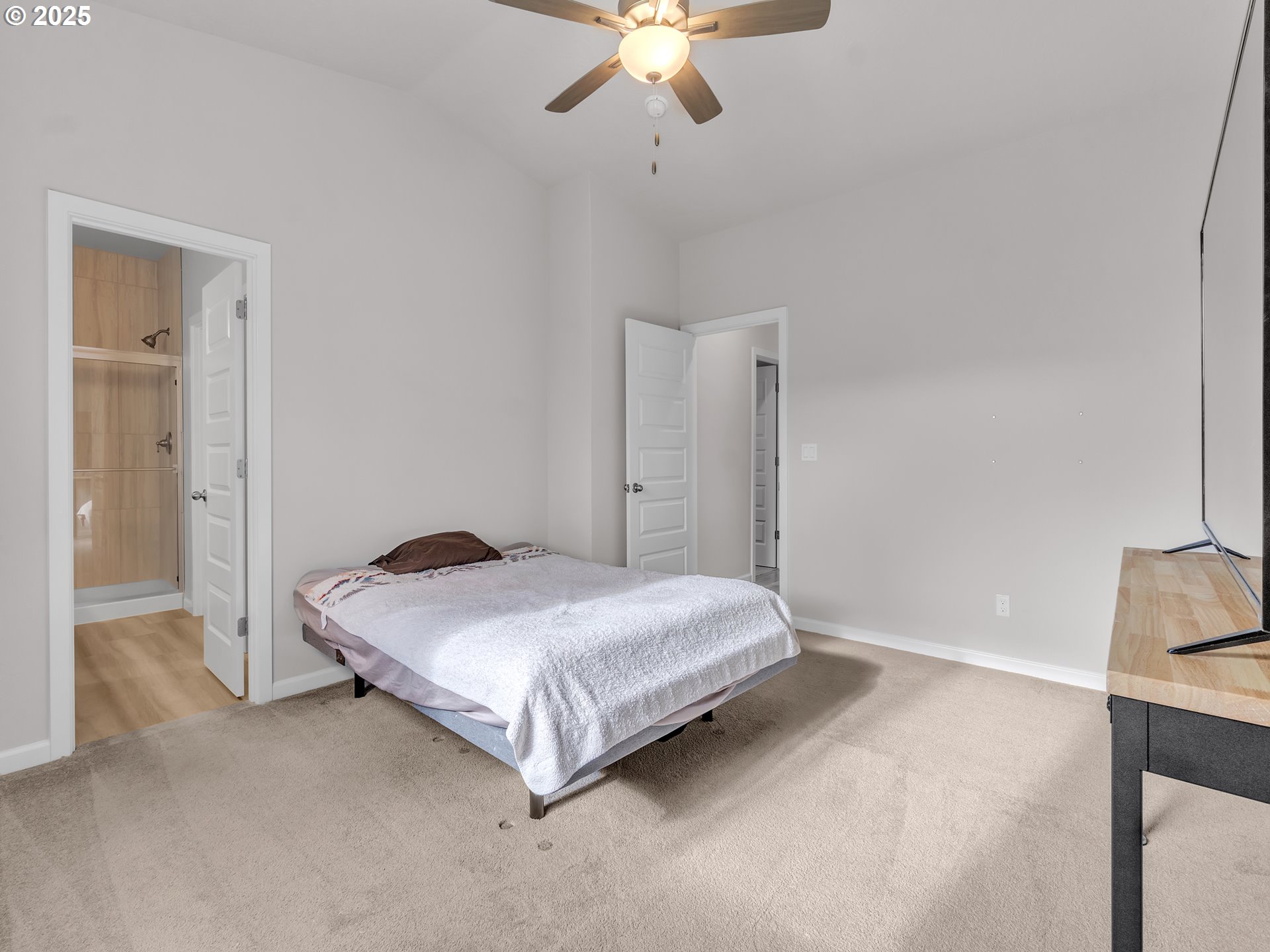 893 East Cleveland Street Carlton, OR 97111 - Photo 12 of 19 a spacious bedroom with a bed and a chandelier