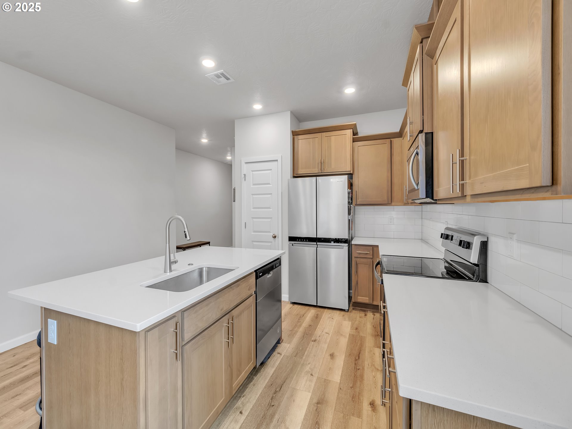 893 East Cleveland Street Carlton, OR 97111 - Photo 8 of 19 a kitchen with a sink a refrigerator and cabinets