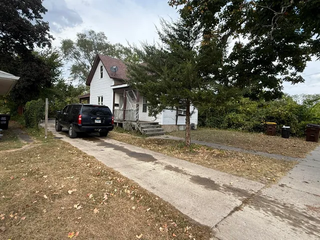 a backyard of a house with yard and outdoor seating
