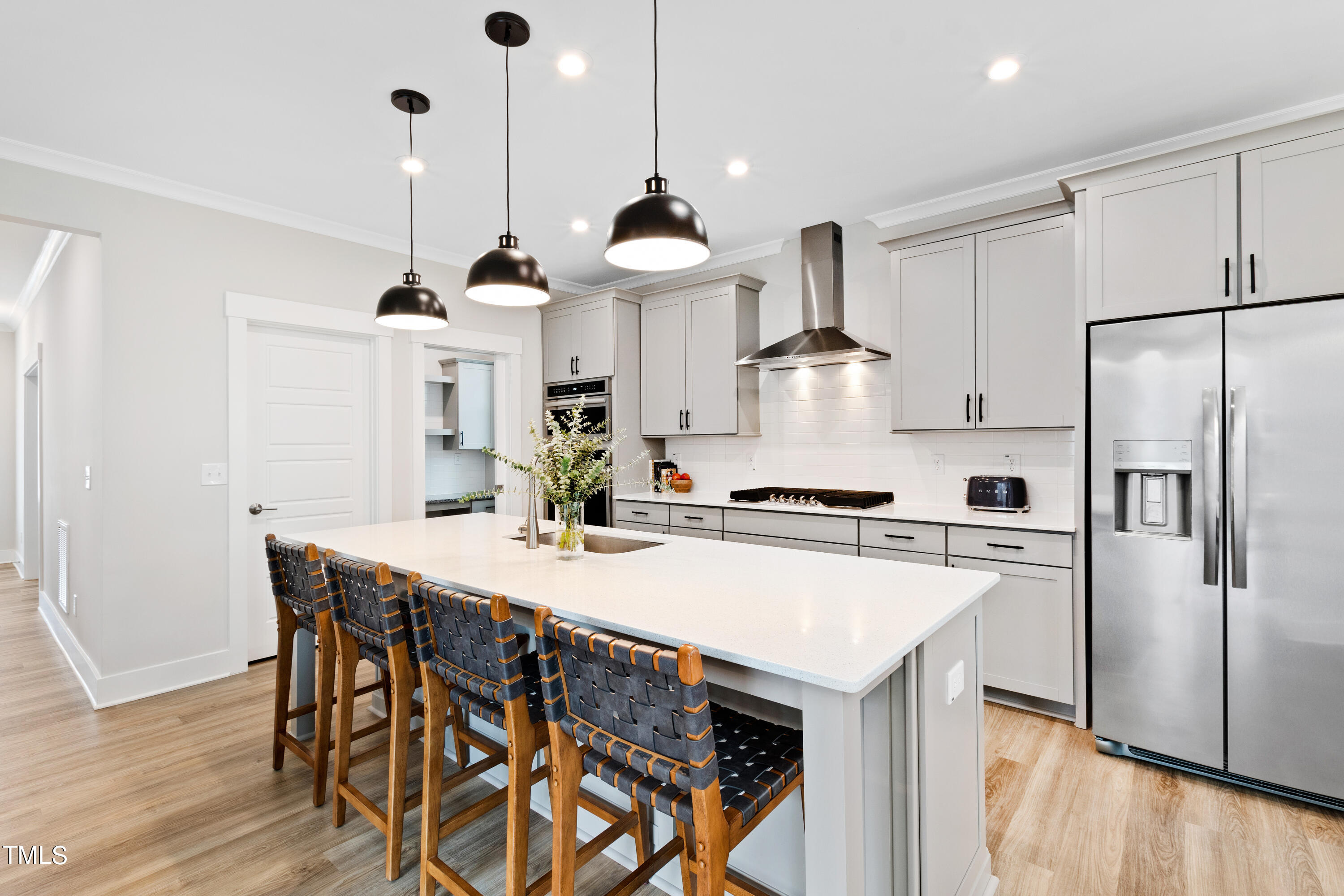 119 Dunloe Loop Raleigh, NC 27603 - Photo 15 of 51 a kitchen with stainless steel appliances a stove a sink island and a refrigerator