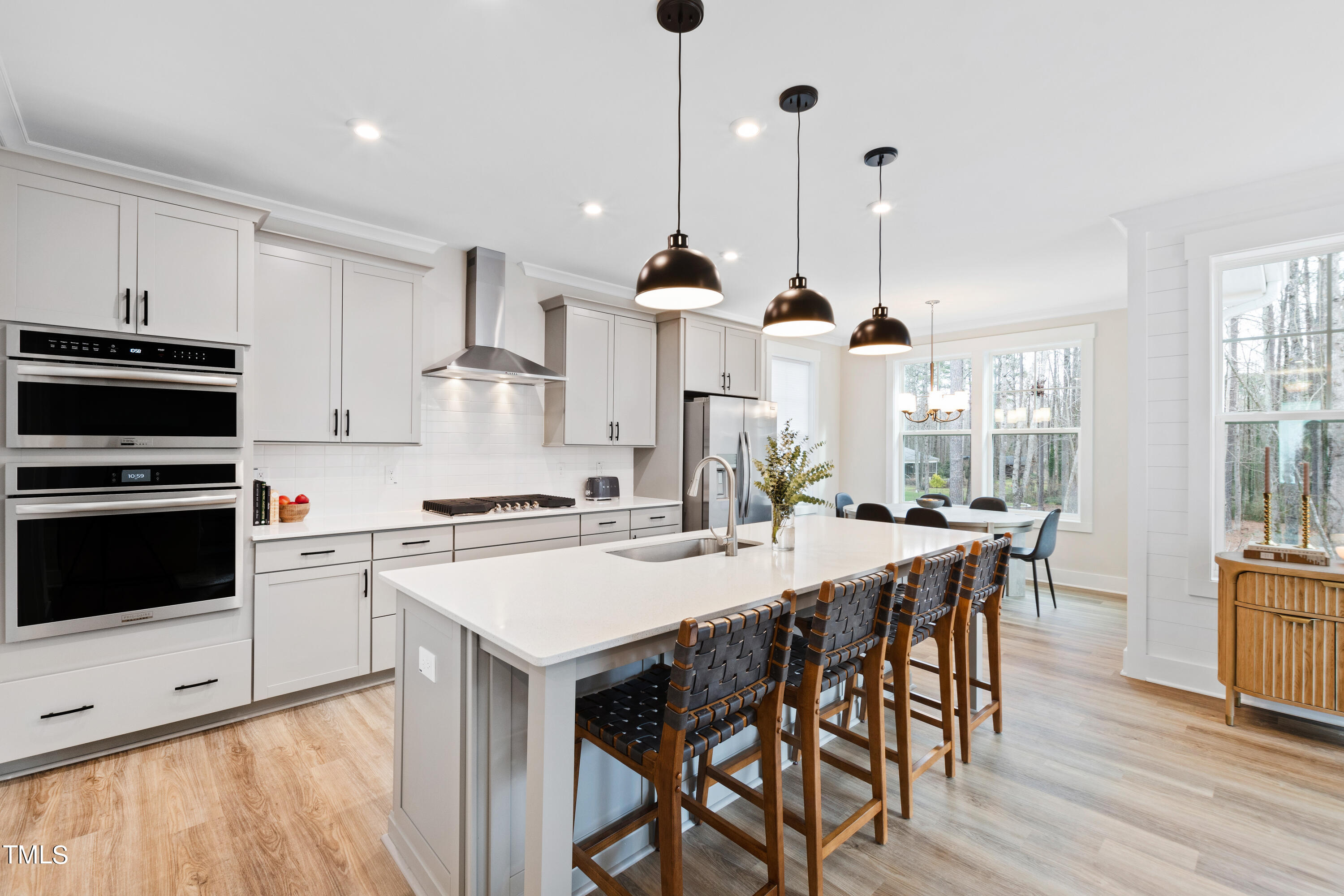 119 Dunloe Loop Raleigh, NC 27603 - Photo 16 of 51 a kitchen with stainless steel appliances granite countertop a stove a sink a microwave a dining table and chairs