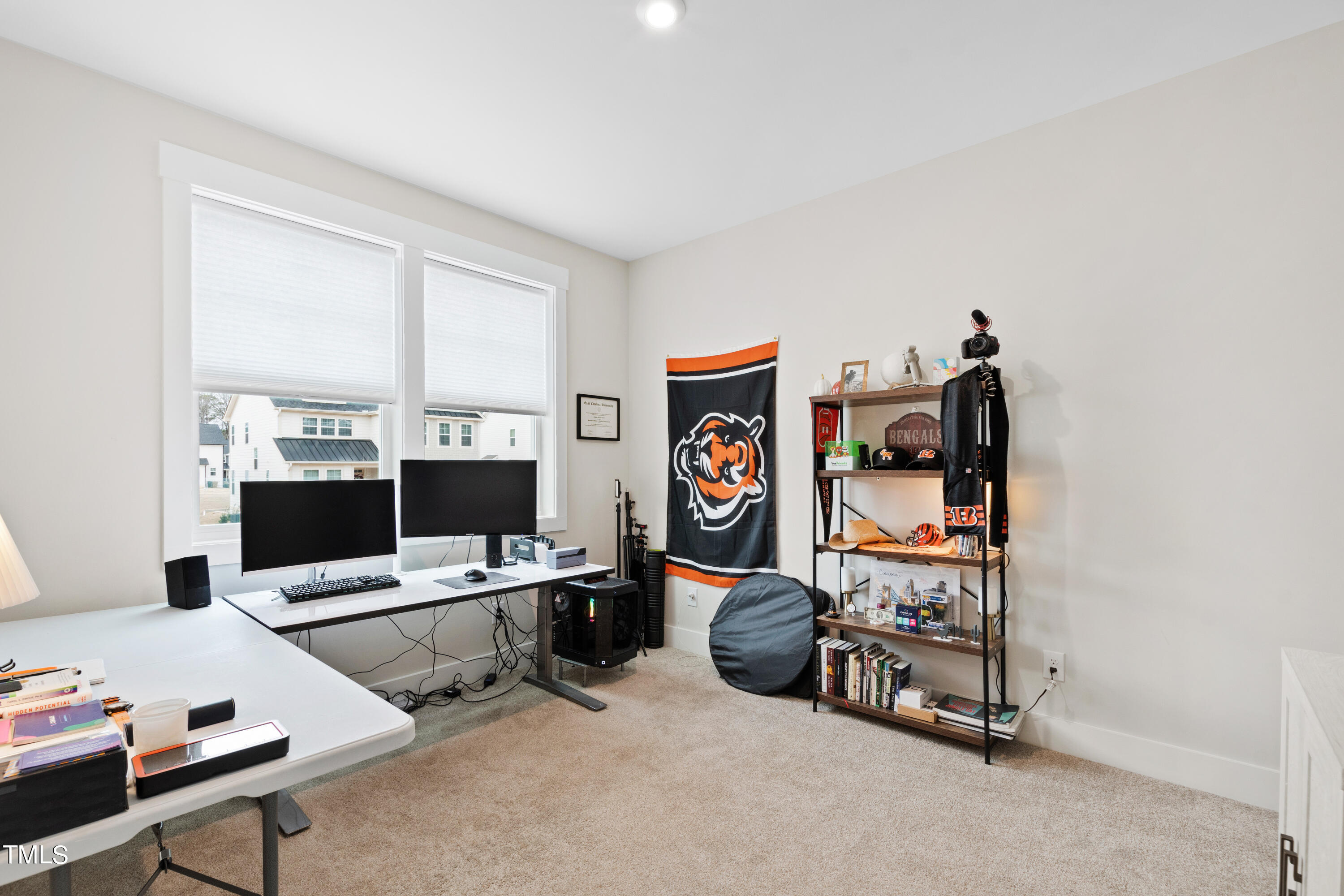 119 Dunloe Loop Raleigh, NC 27603 - Photo 38 of 51 a work room with furniture and a bookshelf