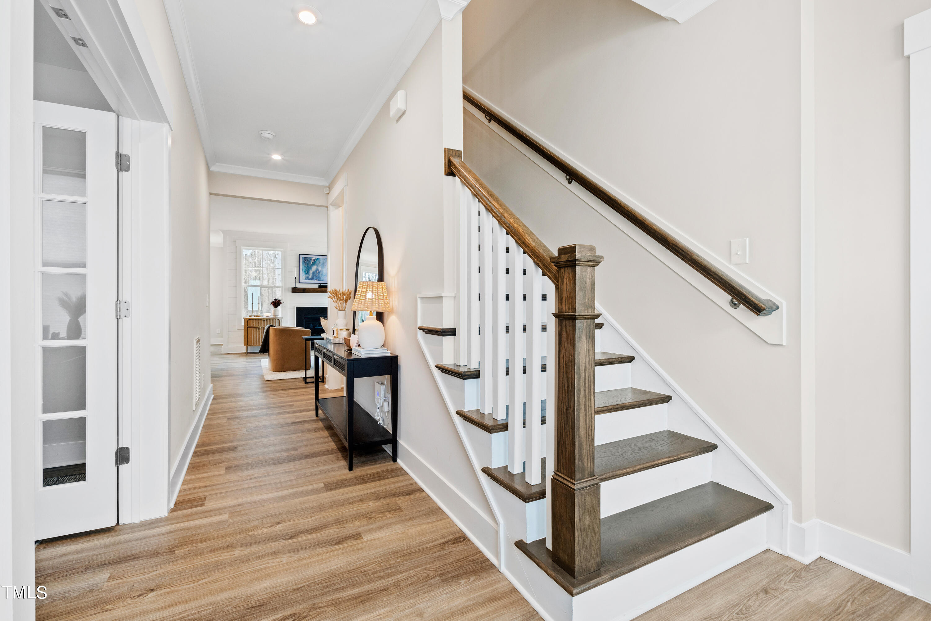 119 Dunloe Loop Raleigh, NC 27603 - Photo 7 of 51 a view of staircase with lots of frames on wall and wooden floor