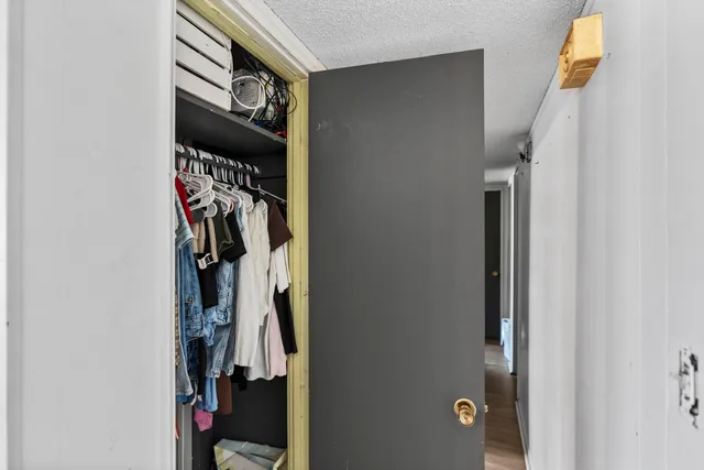 a view of walk in closet with clothes