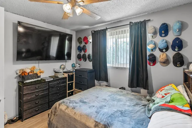 a bedroom with a bed and flat screen tv