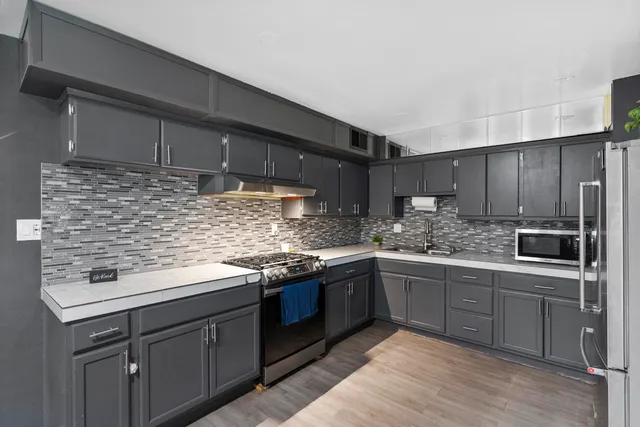 a kitchen with stainless steel appliances granite countertop a sink and cabinets