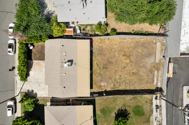an aerial view of a house with a yard