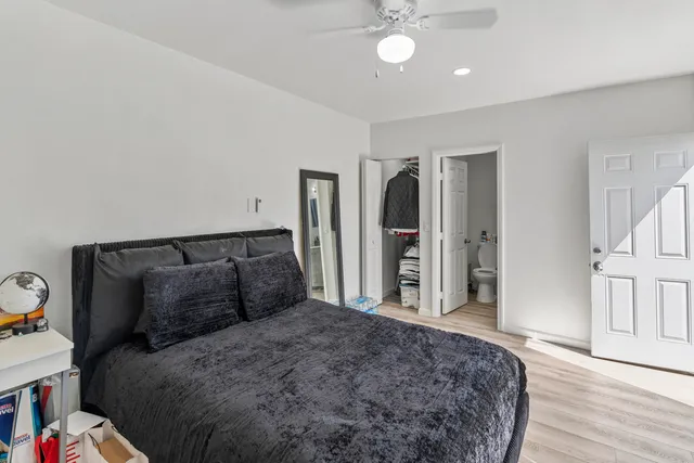 a bedroom with a bed and wooden floor