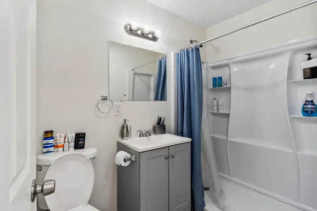 a bathroom with a sink toilet and shower
