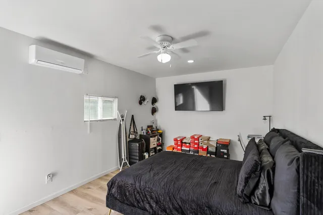 a bedroom with a bed and a chandelier