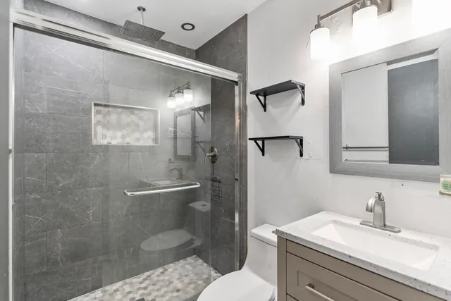 a bathroom with a sink toilet and shower