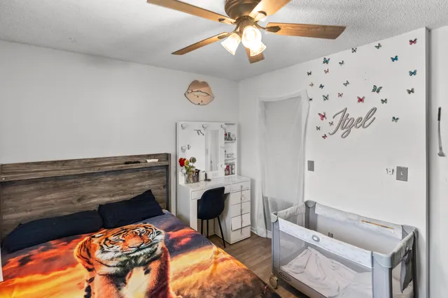 a bedroom with a bed and a chandelier