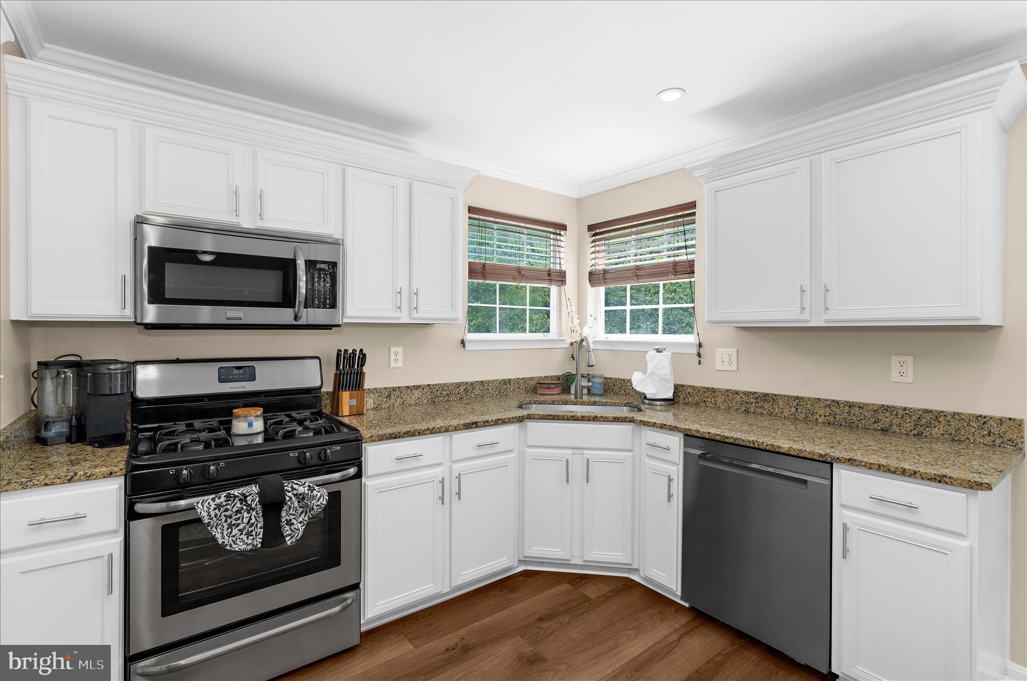 8028 High Oak Road Glen Burnie, MD 21060 - Photo 13 of 65 a kitchen with granite countertop a sink cabinets and stainless steel appliances