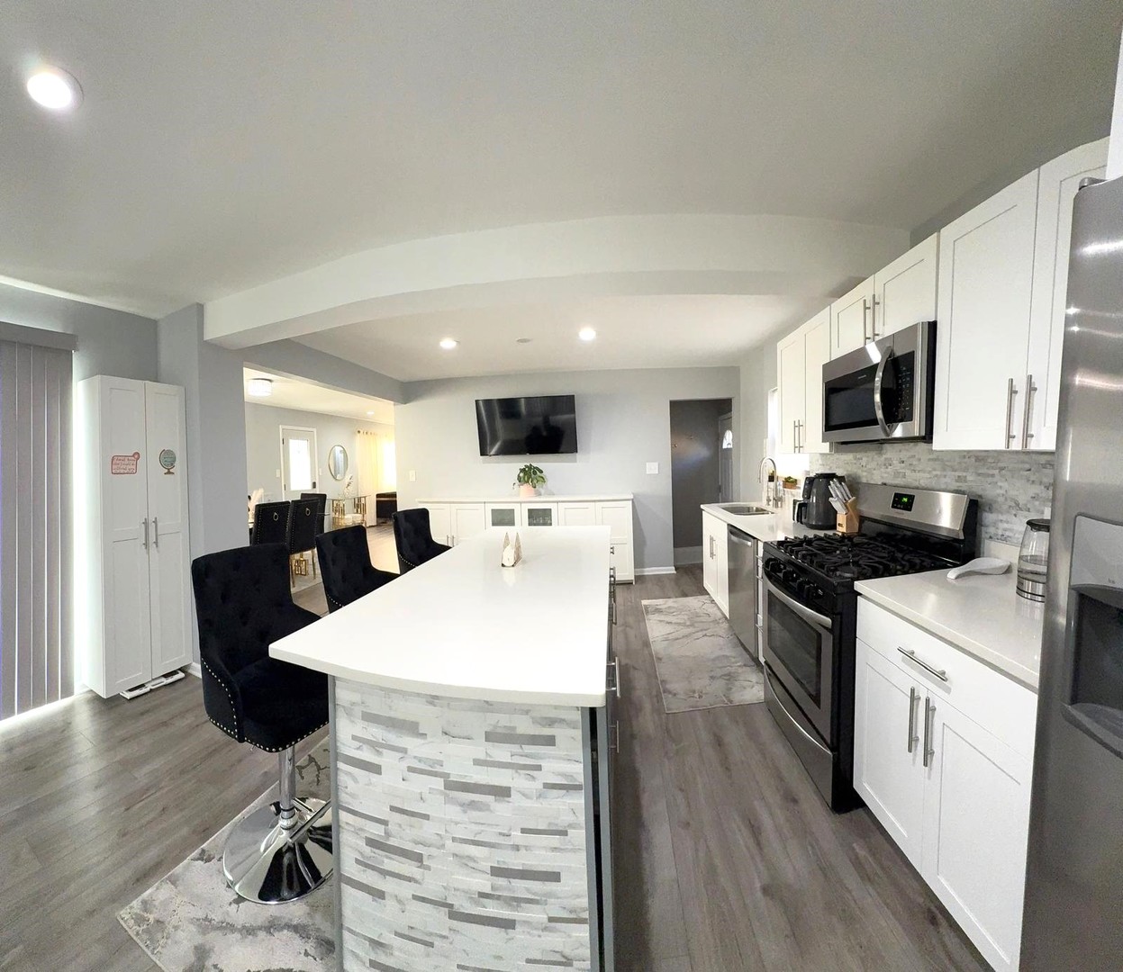 8001 North Elmore Street Niles, IL 60714 - Photo 13 of 34 a open kitchen with stainless steel appliances kitchen island granite countertop a stove top oven a sink dishwasher a dining table and chairs with wooden floor