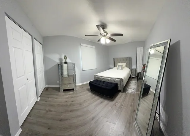 a bedroom with furniture and a mirror