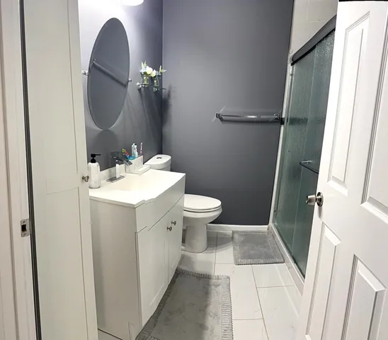 a bathroom with a sink toilet and mirror