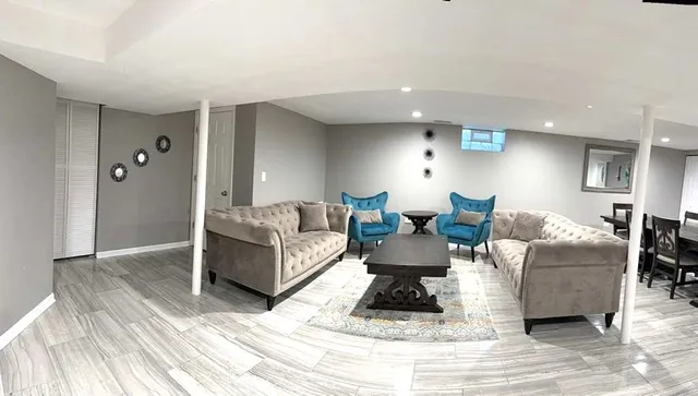 a living room with furniture and a wooden floor