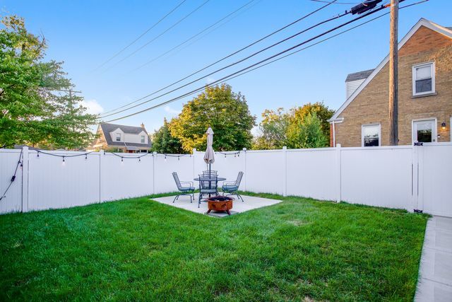 8001 North Elmore Street Niles, IL 60714 - Photo 3 of 34 a backyard of a house with table and chairs