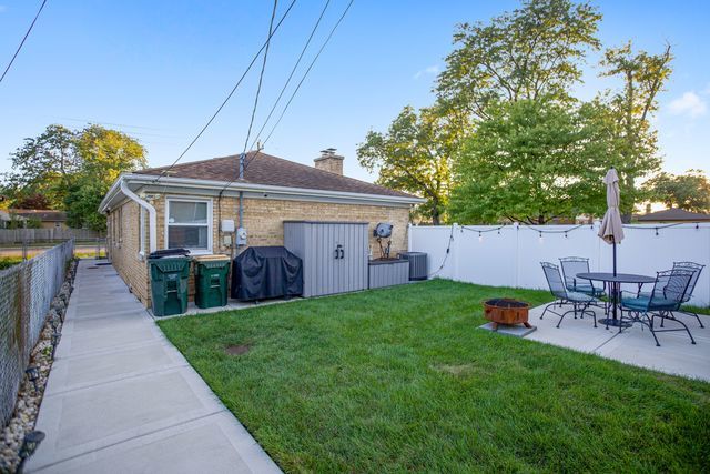 8001 North Elmore Street Niles, IL 60714 - Photo 4 of 34 a view of a house with a yard and sitting area