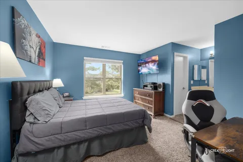 a bedroom with a large bed and a window